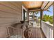Outdoor deck features a table, chairs, and a view of the neighborhood, perfect for relaxation at 807 S Bay Blvd, Anna Maria, FL 34216
