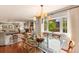 Bright dining room with chandelier, glass table, and view into the living room at 807 S Bay Blvd, Anna Maria, FL 34216