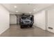 Clean garage featuring a silver jeep, epoxy flooring and new garage door at 807 S Bay Blvd, Anna Maria, FL 34216