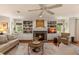 Comfortable living room featuring a cozy fireplace, built-in shelves, and a neutral color palette at 807 S Bay Blvd, Anna Maria, FL 34216