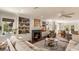 Inviting living room with a fireplace, built-in shelving, and an open layout flowing to the dining area at 807 S Bay Blvd, Anna Maria, FL 34216