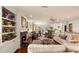 Open concept living room with hardwood floors, fireplace, and seamless flow to dining and kitchen at 807 S Bay Blvd, Anna Maria, FL 34216