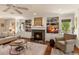 Cozy living room with a fireplace, built-in shelving, and comfortable seating arrangements at 807 S Bay Blvd, Anna Maria, FL 34216
