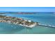 Expansive aerial view of a coastal community with waterfront homes, bridges, and scenic ocean views at 810 Siesta Dr, Sarasota, FL 34242