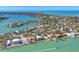 Scenic aerial view of waterfront properties along winding canals, showcasing coastal living at its finest at 810 Siesta Dr, Sarasota, FL 34242