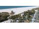 Aerial view of Siesta Key Beach with beachgoers enjoying the sand and surf at 810 Siesta Dr, Sarasota, FL 34242
