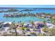 Stunning waterfront home with private dock and boat lift, surrounded by lush landscaping and turquoise waters at 810 Siesta Dr, Sarasota, FL 34242