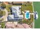 Stunning aerial view of waterfront home, showcasing pool, private dock, and lush landscaping at 810 Siesta Dr, Sarasota, FL 34242