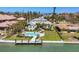 Aerial view showcases a waterfront home with a private pool and boat dock, perfect for coastal living at 810 Siesta Dr, Sarasota, FL 34242