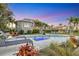 Stunning backyard with a pool, lounge chairs, and lush tropical landscaping at twilight at 810 Siesta Dr, Sarasota, FL 34242