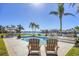 Relax by the pool with tranquil water views, mature palms, and a boat dock for an outdoor paradise at 810 Siesta Dr, Sarasota, FL 34242