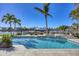 Captivating waterfront view featuring a luxurious pool and spa area complemented by lush landscaping and boat dock at 810 Siesta Dr, Sarasota, FL 34242