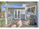 Balcony with outdoor grill, ideal for entertaining and enjoying the tropical ambiance at 810 Siesta Dr, Sarasota, FL 34242