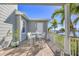 Balcony seating offers serene water views, blending indoor and outdoor living seamlessly at 810 Siesta Dr, Sarasota, FL 34242