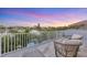 Relaxing balcony with comfortable seating and scenic waterfront views at sunset at 810 Siesta Dr, Sarasota, FL 34242