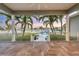 Covered balcony overlooks pool, boat dock, and waterway for a tranquil outdoor living space at 810 Siesta Dr, Sarasota, FL 34242