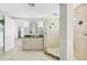 Modern bathroom features a walk-in shower and double vanity with granite countertop at 810 Siesta Dr, Sarasota, FL 34242
