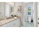 Light and bright bathroom with granite counters, double sinks, and separate lavatory at 810 Siesta Dr, Sarasota, FL 34242