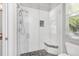 Bright walk-in shower with designer tile surround and built-in bench at 810 Siesta Dr, Sarasota, FL 34242