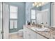 Well-lit bathroom featuring granite countertops, white cabinets, and a large mirror at 810 Siesta Dr, Sarasota, FL 34242