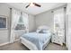 Cozy bedroom with white accents, large windows and ceiling fan at 810 Siesta Dr, Sarasota, FL 34242