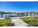 Modern boat dock with a sleek yacht, seating area, and a convenient path to the waterfront at 810 Siesta Dr, Sarasota, FL 34242