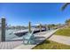 Modern boat dock with a sleek yacht and Adirondack chairs, perfect for enjoying waterfront views at 810 Siesta Dr, Sarasota, FL 34242
