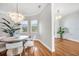 Open dining area featuring stylish chandelier lighting and hardwood flooring at 810 Siesta Dr, Sarasota, FL 34242
