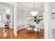 Cozy dining area with modern chandelier lighting and open access to the kitchen at 810 Siesta Dr, Sarasota, FL 34242