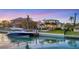 An elegant home with boat dock, backyard pool, and lush landscaping along the waterfront at 810 Siesta Dr, Sarasota, FL 34242
