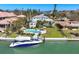 Waterfront home featuring a private dock, boat, pool, and lush landscaping at 810 Siesta Dr, Sarasota, FL 34242