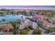 Exterior view of home showcasing waterfront access, lush landscaping, and picturesque sunset at 810 Siesta Dr, Sarasota, FL 34242