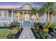 Inviting front entrance with double doors, elegant landscaping, and a paver walkway at 810 Siesta Dr, Sarasota, FL 34242