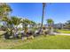 Charming two-story home with a well-maintained lawn, tropical landscaping, and inviting curb appeal at 810 Siesta Dr, Sarasota, FL 34242