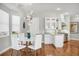 Eat-in kitchen featuring modern lighting, an island, stainless appliances, and wood flooring at 810 Siesta Dr, Sarasota, FL 34242