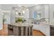 Bright kitchen features an island with stainless steel appliances and granite countertops at 810 Siesta Dr, Sarasota, FL 34242