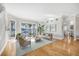 Open-concept living room with wood floors, waterfront views, and stylish modern decor at 810 Siesta Dr, Sarasota, FL 34242