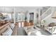 Bright living area featuring hardwood floors and an open layout with views of the entryway at 810 Siesta Dr, Sarasota, FL 34242