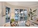Comfortable living room with large windows offering views of the backyard pool and waterfront at 810 Siesta Dr, Sarasota, FL 34242