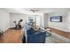 Living room with entertainment center, wood floors and exercise area at 810 Siesta Dr, Sarasota, FL 34242