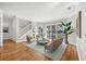 Bright living room with waterfront views, stylish furnishings, and a staircase to the second floor at 810 Siesta Dr, Sarasota, FL 34242