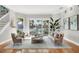 Bright and airy living room with stunning waterfront views, hardwood floors, and stylish furniture at 810 Siesta Dr, Sarasota, FL 34242