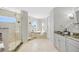 Luxurious main bathroom featuring a glass shower, soaking tub, and marble countertops at 810 Siesta Dr, Sarasota, FL 34242