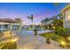 Twilight view of private pool and boat dock, perfect for luxury outdoor living at 810 Siesta Dr, Sarasota, FL 34242