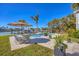 Pool with outdoor seating, mature palm trees, and waterfront views for relaxation at 810 Siesta Dr, Sarasota, FL 34242