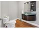 Stylish powder room with a unique glass sink, modern vanity, and hardwood floors at 810 Siesta Dr, Sarasota, FL 34242