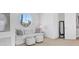 Cozy sitting area featuring comfortable seating and abundant natural light from the large window at 810 Siesta Dr, Sarasota, FL 34242