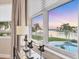 View from a window overlooking a pool and waterfront at 810 Siesta Dr, Sarasota, FL 34242