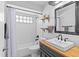 Bathroom features striking black and white tile flooring and a sleek vanity with a wooden countertop at 820 Faulkwood Ct, Sarasota, FL 34232