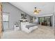 Neutral bedroom with a ceiling fan, large windows and ensuite bathroom at 820 Faulkwood Ct, Sarasota, FL 34232